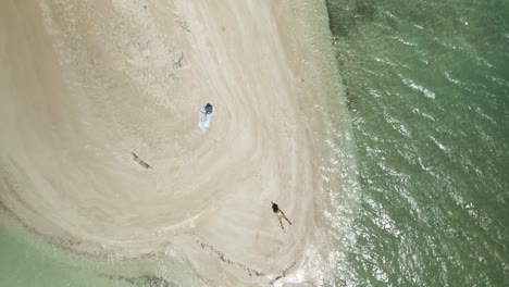 Thong-bikini-model-laying-in-the-white-sand-beach-of-No-Man-Land,-Tobago
