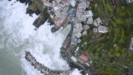 Aerial-view-of-Riomaggiore,-Cinque-Terre,-during-a-sea-storm