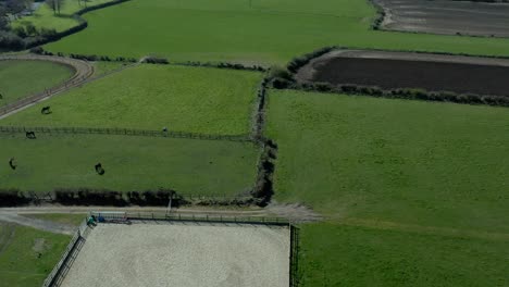 Aerial-wide-angle-of-green-field-at-rural-area-at-day,-no-people