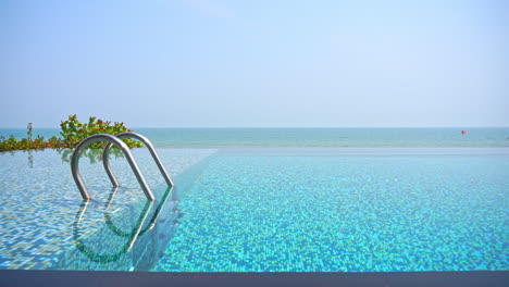 The-edge-of-an-infinity-pool-creates-a-seamless-view-with-the-ocean-in-the-background
