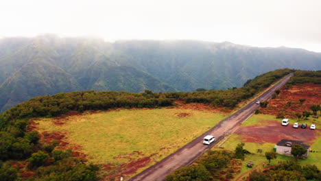 Aerial-view-of-a-van-driving-high-in-the-Mountains-of-Madeira---tracking,-drone-shot