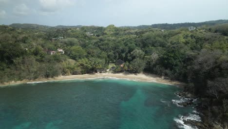 Aerial-reveal-of-Arnos-Vale-beach-with-a-shallow-reef-excellent-for-snorkeling