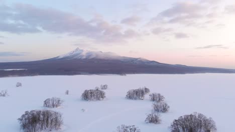 Aerial-sideways-flight-over-frozen-landscape-in-Onuma-National-Park