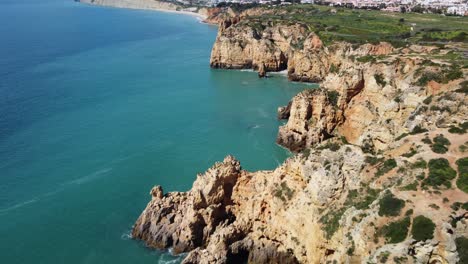 Incredible-Aerial-View-Of-Coastal-Rock-Formations-With-Caves,-Ponta-Da-Piedade,-Portugal