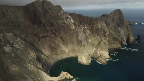 Spectacular-view-of-volcanic-cliffs-with-blue-Atlantic-ocean-water,-aerial