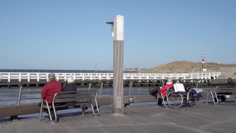 People-enjoying-the-view-at-the-eastern-palisade,-Nieuwpoort,-Belgium,-wide-shot