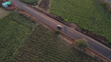 drone-following-Inova-car-from-top-in-rural-village-farm-road-cinematic-in-sunset-sunrise-Maharashtra-India-osmanabad