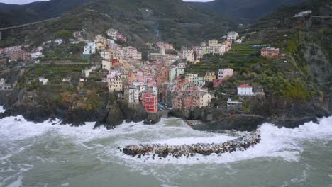 Aerial-view-of-Riomaggiore,-5-Terre,-during-a-storm-sea