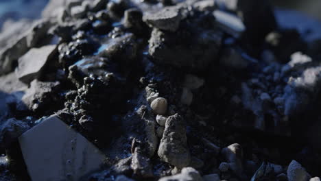 Close-up-of-water-Landslide-on-rocky-muddy-surface-smooth-macro-dolly-shot