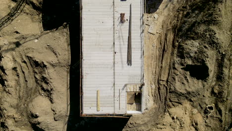 top-down-over-construction-site,-concrete-screed,-aerial