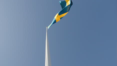 Close-up,-slow-motion-view-of-the-Swedish-flag-waving-in-the-spring-wind