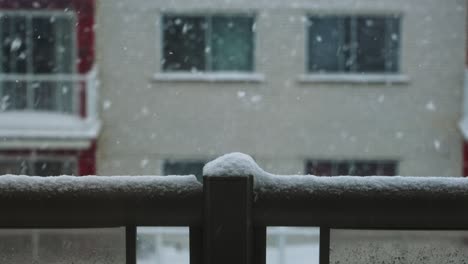 Slow-Motion-CloseUp-of-Balcony-Rail-with-Snow-Falling