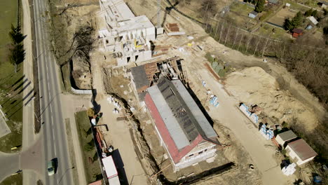 top-down-empty-construction-site-with-building-crane,-aerial