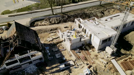 Aerial-view-showing-old-rustic-restaurant-building-beside-new-build-building-on-construction-site-during-summer