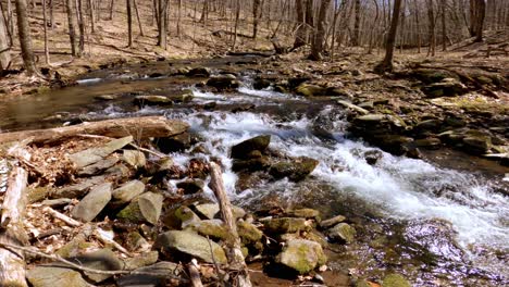 -A-beautiful,-gentle-mountain-stream-with-a-tiny-waterfall-during-early-spring,-after-snow-melt,-in-the-Appalachian-mountains
