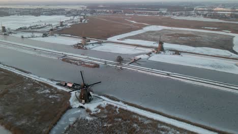 Historic-windmills-in-Netherlands-during-winter,-Unesco-site,-aerial