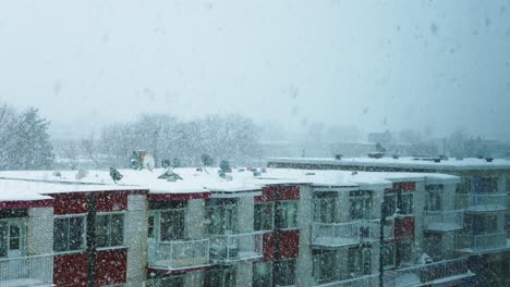 Heavy-Snow-Blizzard-Over-Empty-City-Apartment-Building-Roofs-in-Slow-Motion