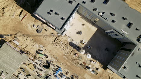 top-down-from-building-place-with-new-home-during-building-proces,-zoom-out-aerial