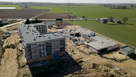 Construction-Process-Of-A-Multi-Storey-Building-With-Green-Meadows-In-Background-At-Lubawa,-Poland