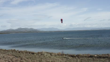 Kitesurfing---Aerial-View-Of-Kiteboarder-Having-Fun-On-Water-In-Sardinia