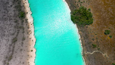 Tilting-up-drone-shot-of-amazing-clear-blue-waters-at-Bacalar-Mexico