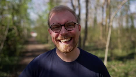 Excited-Handsome-Caucasian-Man-with-Glasses-Laughing,-Close-Up-in-Nature