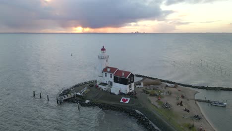 Dramatic-sunrise-at-Horse-of-Marken-lighthouse-at-Markermeer,-Holland
