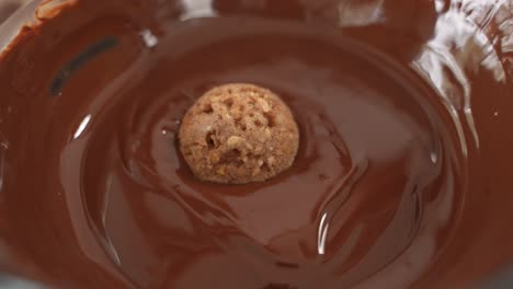Dropping-Healthy-Outmeal-Snack-into-Bowl-of-Chocolate,-Slow-Motion,-Close-Up