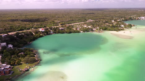 Drone-shot-of-homes-and-turquoise-waters-at-Bacalar-Mexico