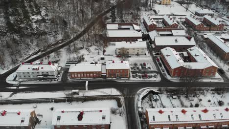 Aerial-view-showing-snow-covered-rooftops-during-snowy-winter-day-in-Jonsered,-Sweden