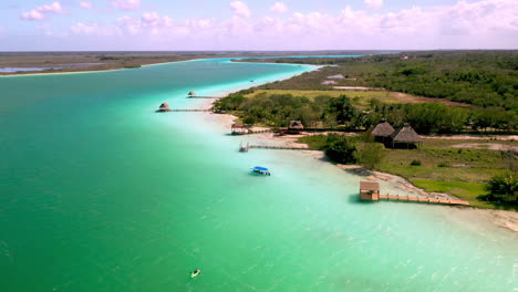 Rotating-drone-shot-of-piers-and-docks-on-turquoise-waters-in-Bacalar-Mexico