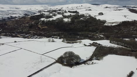 Winter-landscape-with-farms-and-snow-covered-open-field