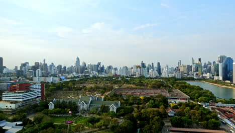 Timelapse-of-Bangkok,-Thailand,-Buildings,-Skyscrapers-and-Temple-by-Benjakitti-Park-on-Cloudy-Day