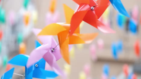 Colourful-plastic-pinwheels-rotate-with-blowing-wind