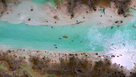 Cinematic-downward-angle-drone-shot-of-Kayakers-in-clear-blue-waters-at-Bacalar-Mexico