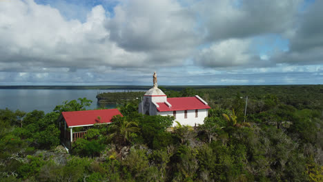 Aerial-view-tilting-over-the-Chapelle-Notre-Dame-de-Lourdes,-in-Lifou,-New-Caledonia---rising,-drone-shot