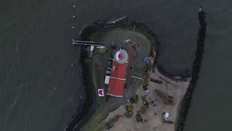 Directly-above-Dutch-Lighthouse-at-Markermeer,-Horse-of-Marken
