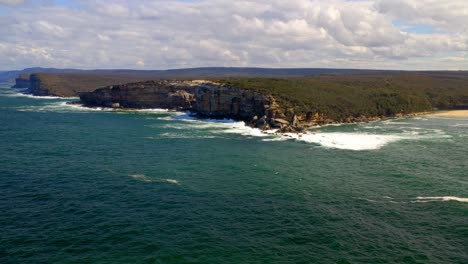 Coastal-Cliffs-And-Lush-Vegetation-Near-Wattamolla-Beach-In-Royal-National-Park,-Australia---aerial-shot