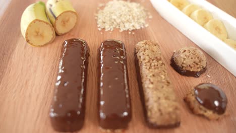 Fresh-Oatmeal-Power-Bars-with-Chocolate-and-Bananas-Displayed-on-Wooden-Table