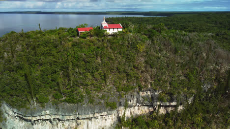 Aerial-view-of-a-hilltop-Chapel,-in-Lifou,-New-Caledonia---circling,-drone-shot