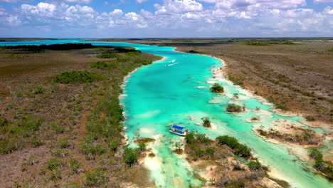 Cinematic-drone-shot-of-clear-blue-waters-and-jet-skiers-at-Bacalar-Mexico
