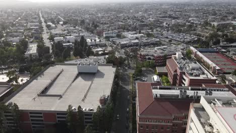 Over-USC-Campus,-city-of-Los-Angeles,-aerial-view-of-rooftop-buildings