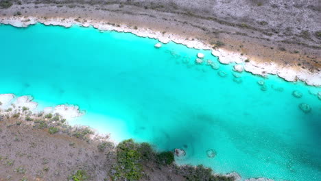 Cinematic-drone-shot-of-the-clear-blue-waters-at-Bacalar-Mexico-with-cloud-shawdows