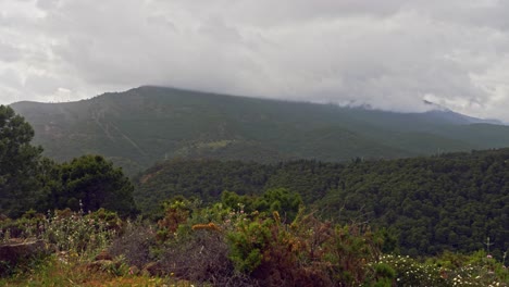 Slow-panoramic-shot-of-Sierra-de-Las-Nieves,-Spain,-on-a-dark-cloudy-day
