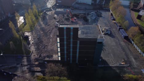 Demolished-multi-storey-car-park-concrete-construction-site-excavation-in-town-regeneration-aerial-view-demolition