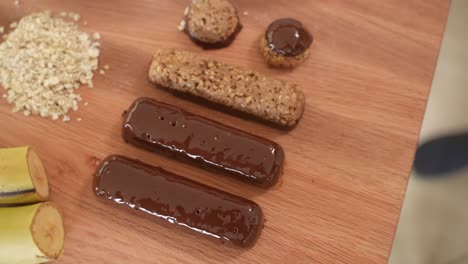 Healthy-Homemade-Snack-Bars-on-Wooden-Table,-Top-Down-in-Slow-Motion