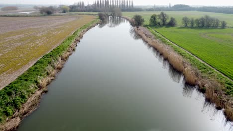 Low-aerial-drone-shot-of-the-River-Stour-in-Kent,-England