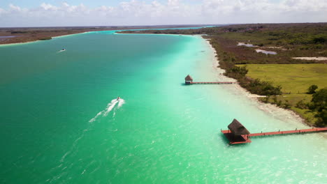 Chasing-drone-shot-of-jet-skier-n-turquoise-waters-at-Bacalar-Mexico