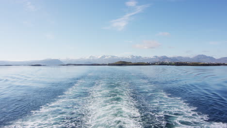 Ocean-view-from-ship-back-with-majestic-mountain-range-in-distance