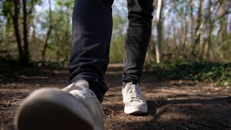 Close-Up-of-Foot-with-White-Shoes,-Walk-on-Hiking-Trail-in-Forest,-Slow-Motion